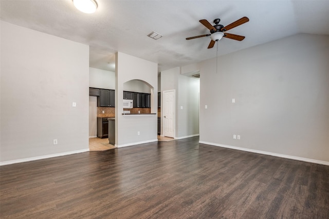 unfurnished living room featuring vaulted ceiling, ceiling fan, and dark hardwood / wood-style floors