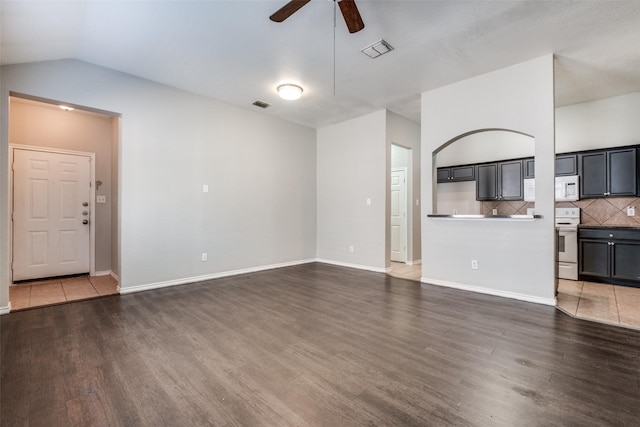 unfurnished living room featuring vaulted ceiling, ceiling fan, and dark hardwood / wood-style floors