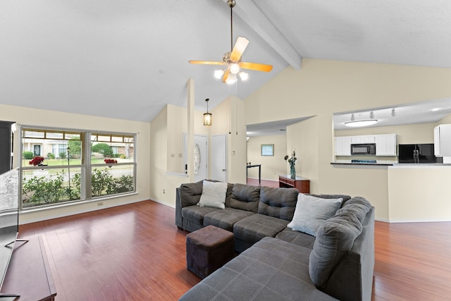 living room with ceiling fan, dark hardwood / wood-style floors, and vaulted ceiling with beams