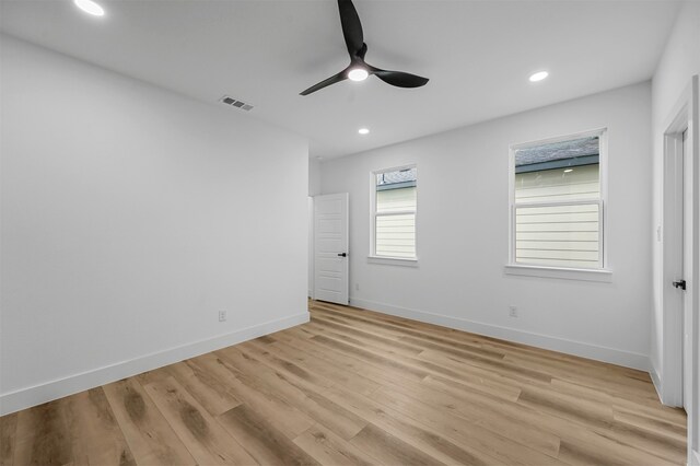 empty room with light hardwood / wood-style flooring and ceiling fan