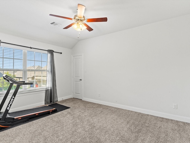 workout area featuring ceiling fan, carpet, and vaulted ceiling