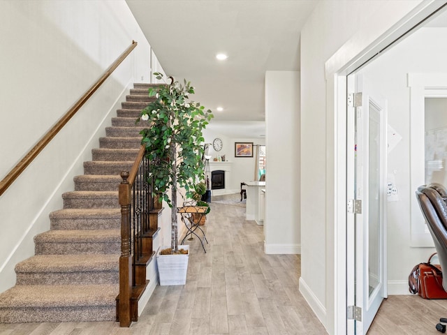 stairway with hardwood / wood-style floors