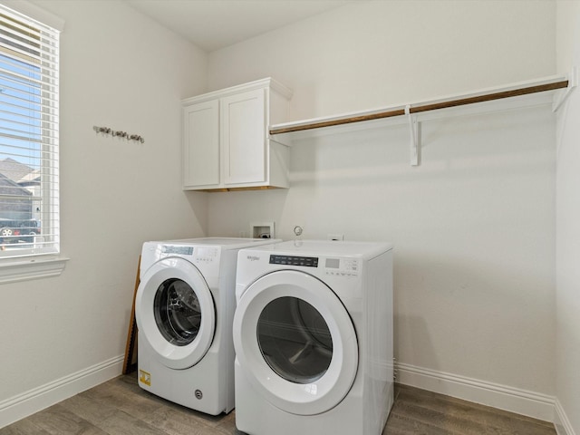 clothes washing area with independent washer and dryer, cabinets, and wood-type flooring