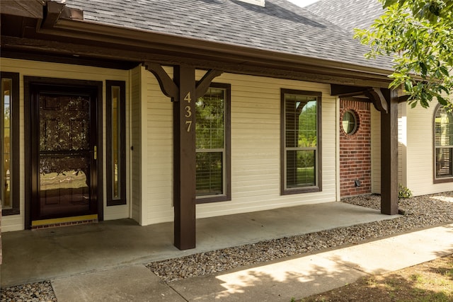 view of exterior entry featuring a porch