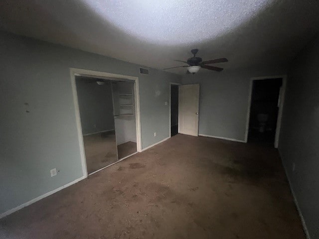 unfurnished bedroom featuring a textured ceiling, ceiling fan, and a closet