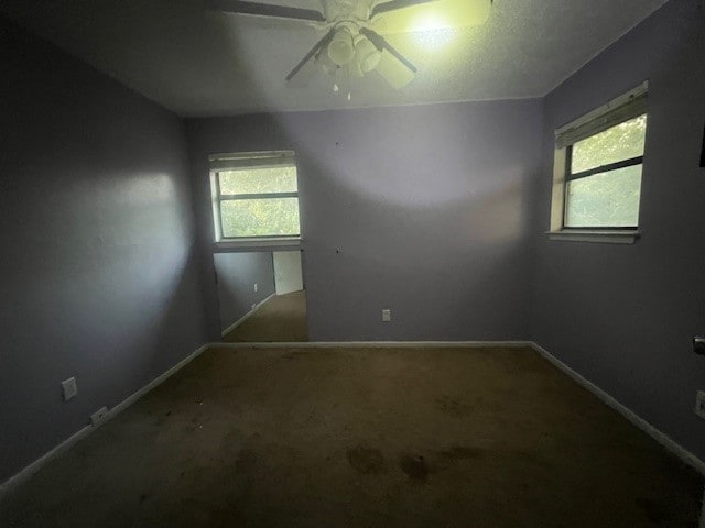 carpeted empty room featuring ceiling fan