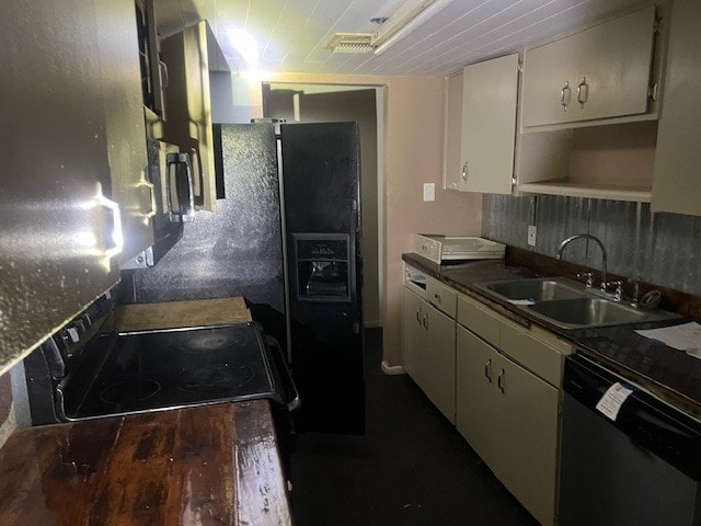 kitchen featuring black appliances, wooden counters, and sink