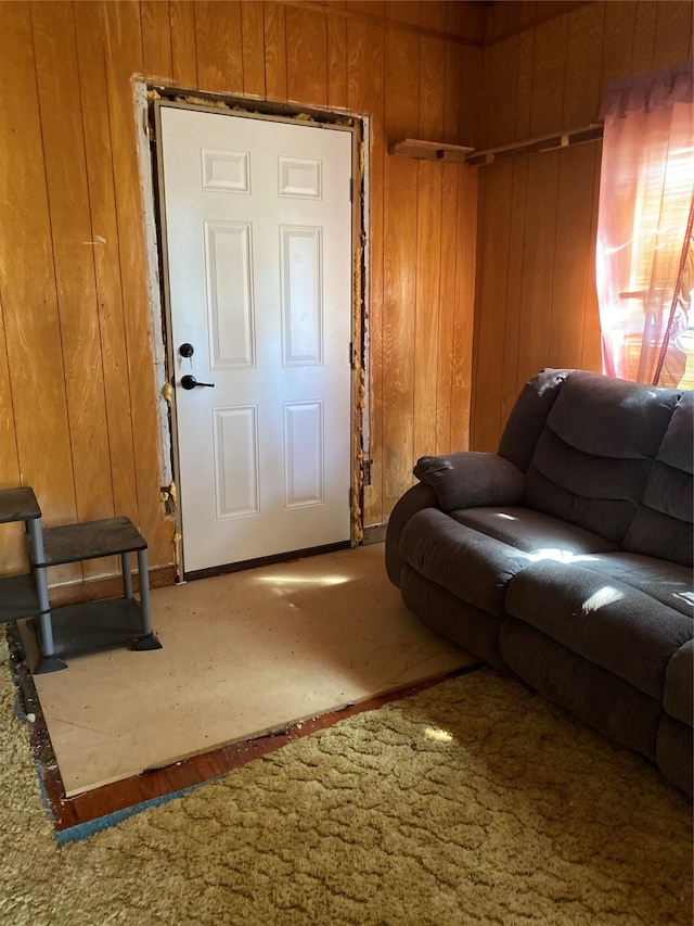 living room with hardwood / wood-style floors and wooden walls