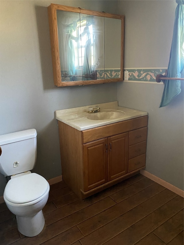 bathroom featuring vanity, toilet, and wood-type flooring