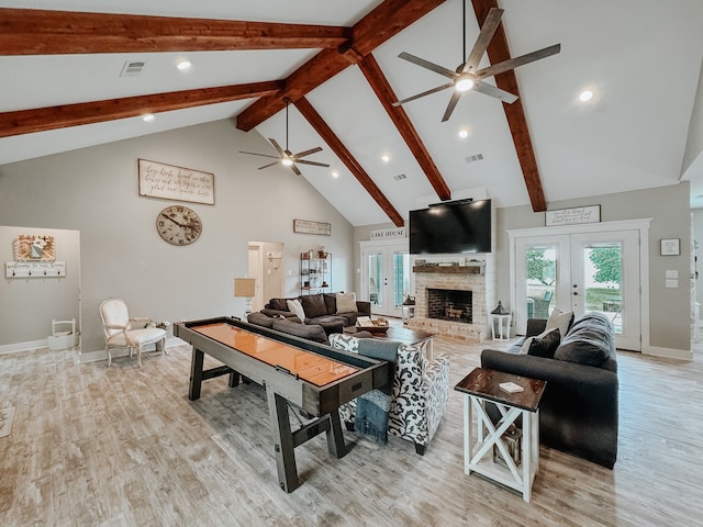 living room featuring light hardwood / wood-style flooring, ceiling fan, high vaulted ceiling, and french doors