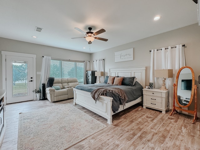 bedroom featuring ceiling fan, light wood-type flooring, and access to outside