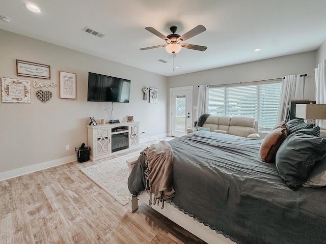 bedroom with ceiling fan, access to exterior, and light hardwood / wood-style flooring