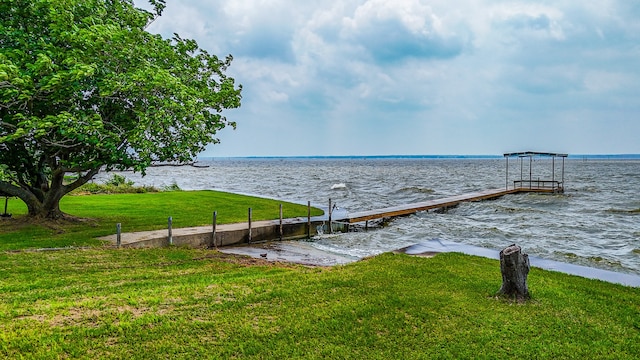 view of dock featuring a yard and a water view