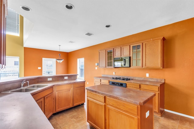 kitchen with a center island, sink, pendant lighting, and a wealth of natural light