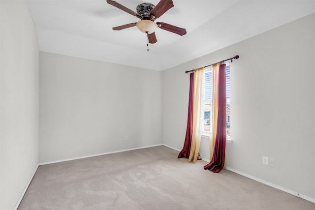 empty room with light colored carpet and ceiling fan