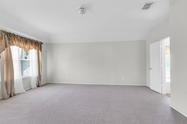 unfurnished room with lofted ceiling and carpet floors