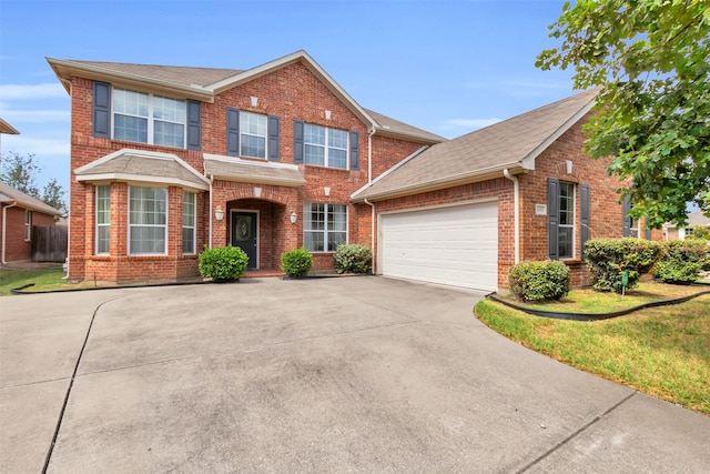 view of front of property featuring a front yard and a garage