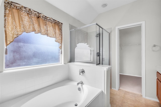 bathroom with vanity, tile patterned floors, lofted ceiling, and separate shower and tub