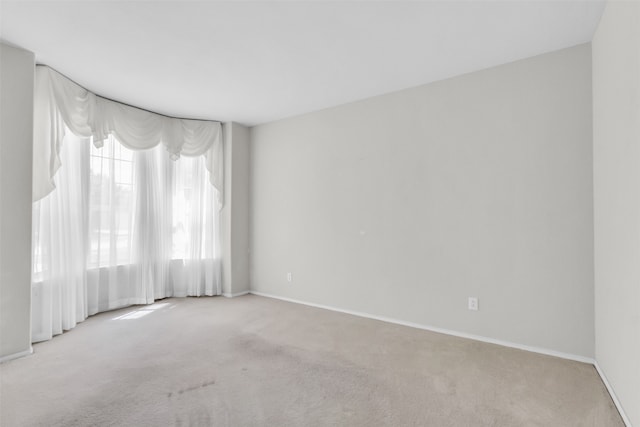 spare room featuring light colored carpet