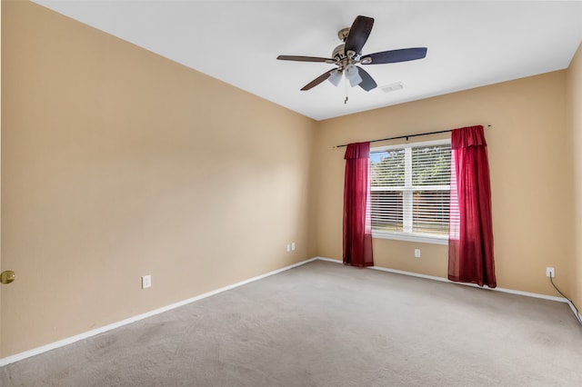 carpeted spare room featuring ceiling fan