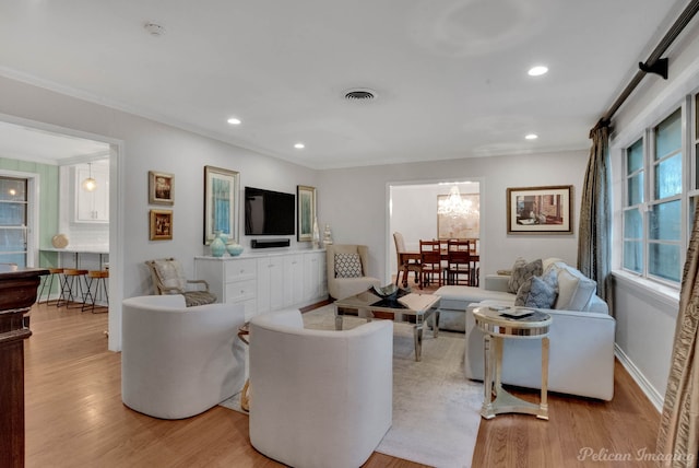 living room featuring light hardwood / wood-style floors and ornamental molding