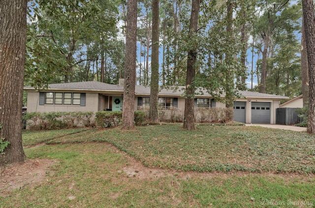 ranch-style home featuring a garage and a front yard