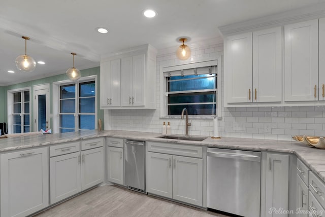 kitchen with dishwasher, decorative backsplash, white cabinets, and sink