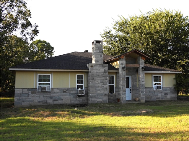 back of house with cooling unit and a yard