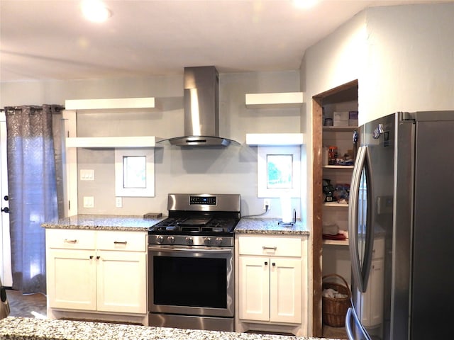 kitchen featuring light stone countertops, stainless steel appliances, and range hood