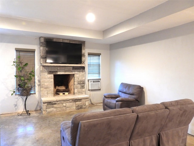 living room with a fireplace, cooling unit, and concrete floors