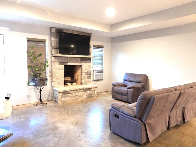 living room with cooling unit, light wood-type flooring, and a fireplace