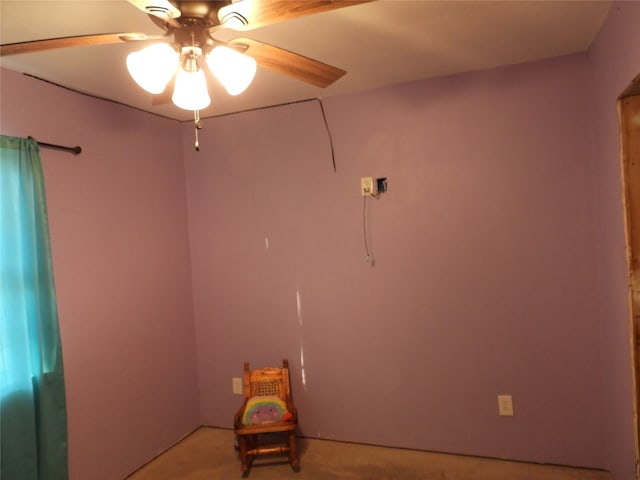 spare room featuring light colored carpet and ceiling fan