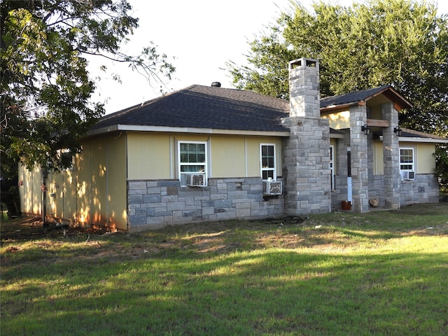 view of property exterior with a yard and cooling unit