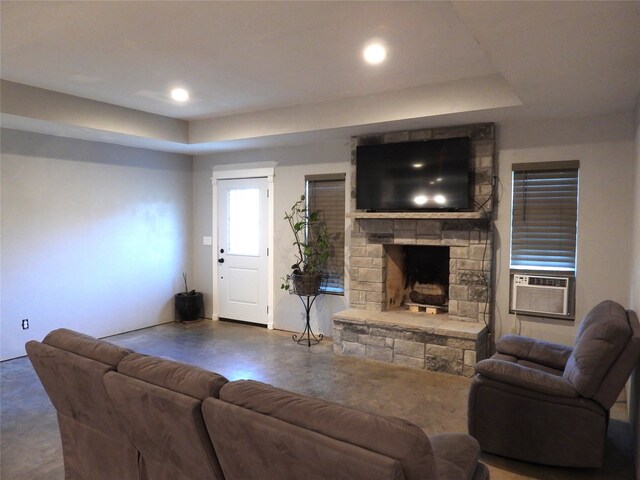 living room featuring cooling unit, concrete flooring, and a fireplace