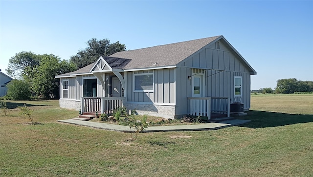 exterior space featuring covered porch and a lawn