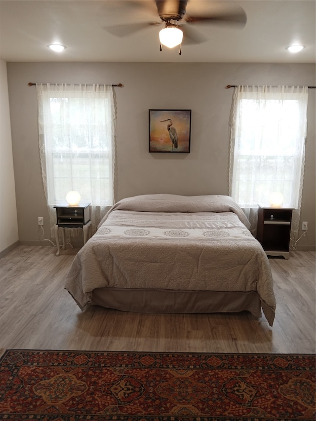 bedroom featuring light hardwood / wood-style flooring and ceiling fan