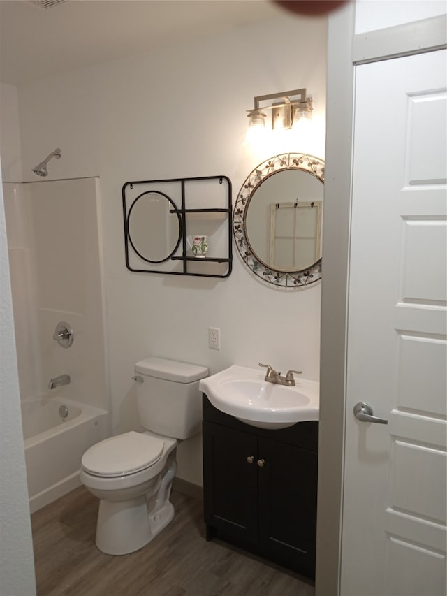 full bathroom with vanity, toilet, wood-type flooring, and shower / tub combination