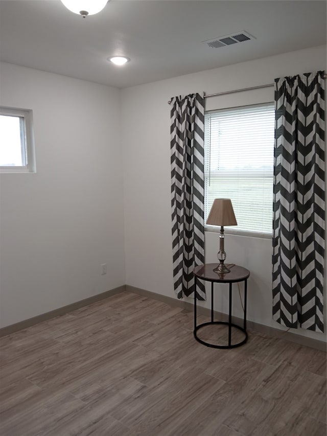 spare room featuring hardwood / wood-style floors and a wealth of natural light