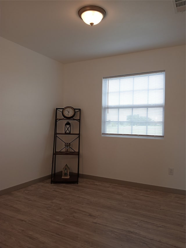 spare room featuring dark hardwood / wood-style floors