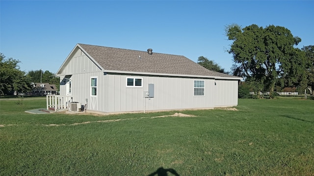 back of house featuring a yard and cooling unit