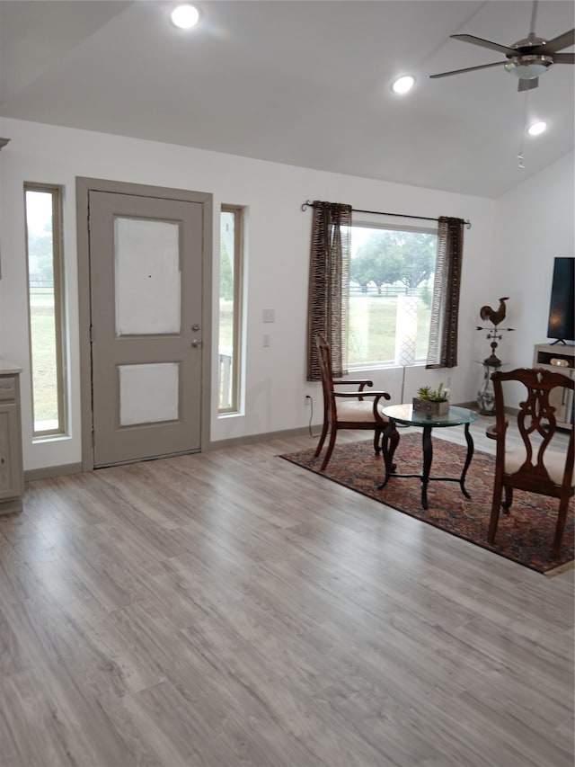 entrance foyer featuring light hardwood / wood-style flooring, ceiling fan, and vaulted ceiling