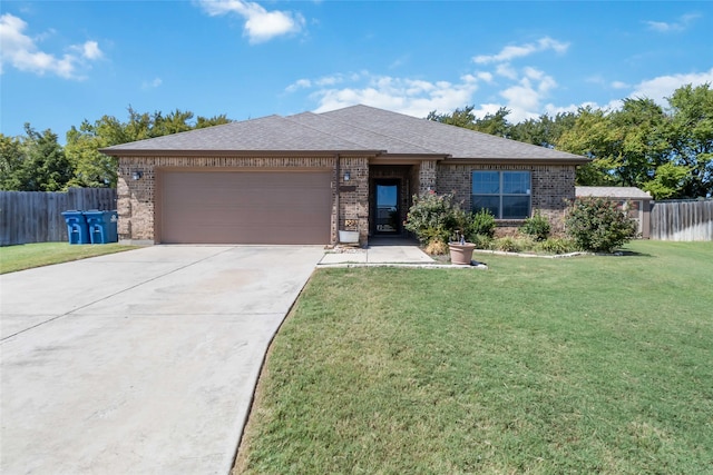 view of front of home featuring a front yard and a garage