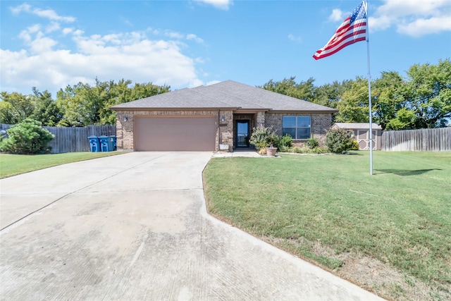 view of front of home featuring a garage and a front yard