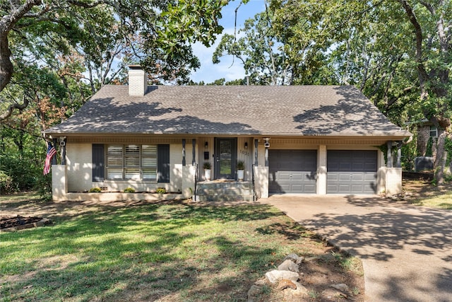 ranch-style house featuring driveway, a front lawn, an attached garage, brick siding, and a chimney