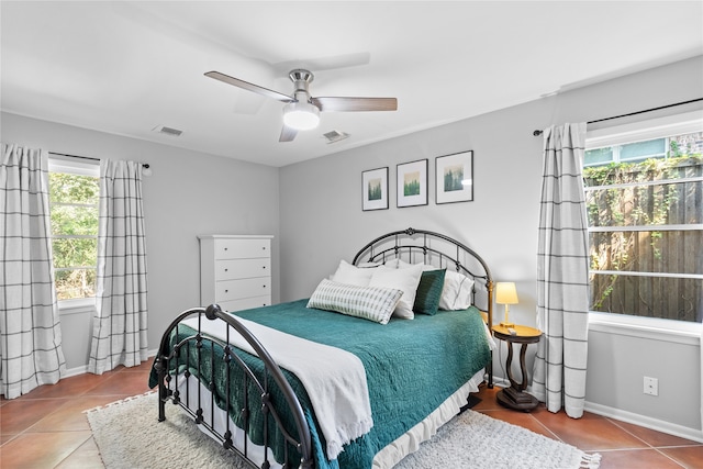 tiled bedroom featuring ceiling fan