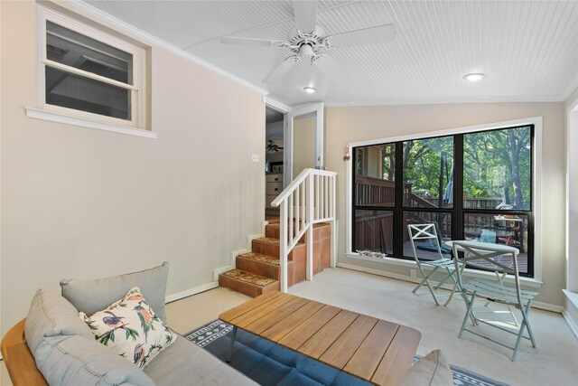 living room featuring ornamental molding, vaulted ceiling, light carpet, and ceiling fan