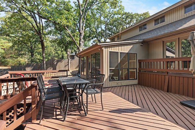 wooden deck featuring a sunroom