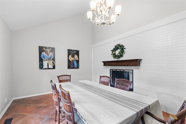 tiled dining space with lofted ceiling and a chandelier