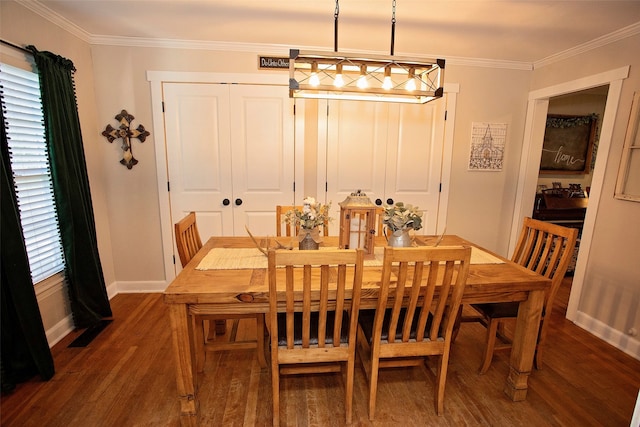 dining space with dark hardwood / wood-style floors and ornamental molding