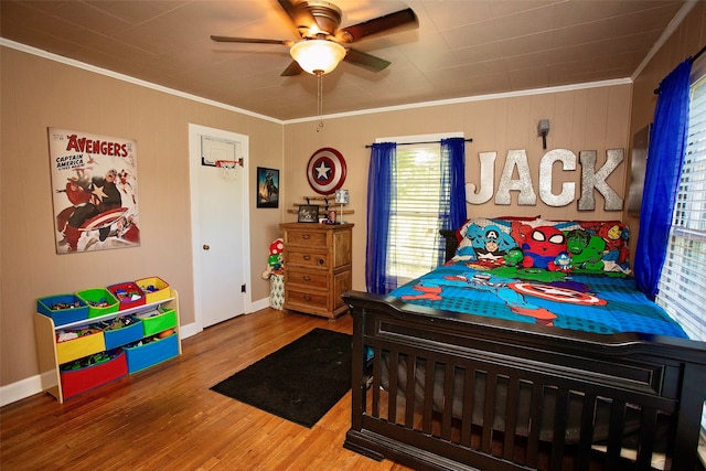 bedroom with wood-type flooring, ceiling fan, and crown molding